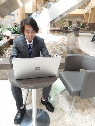 Calgary Local search expert Henry Tsang working on his laptop in a office space